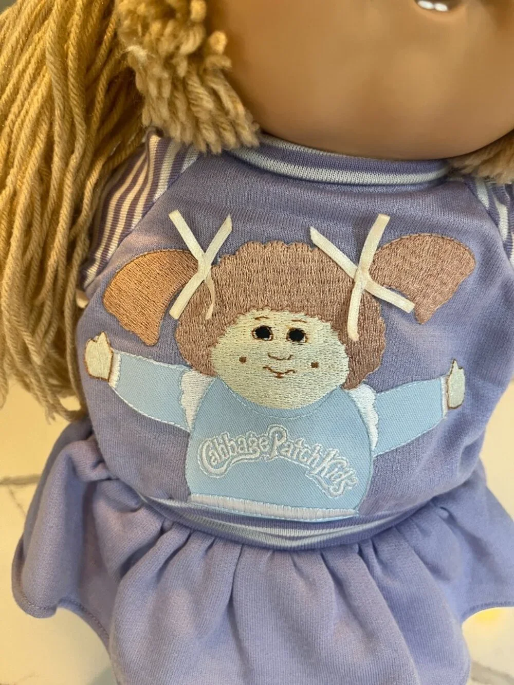 Wheat Lion's Mane Cabbage Patch Kids Doll Wearing Purple Self Portrait Dress